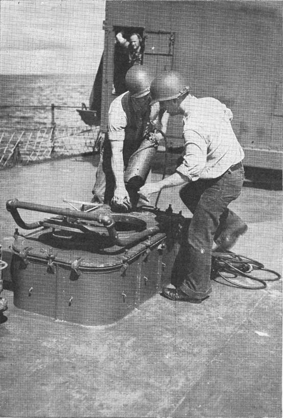 Figure 18-A. Portable electric submersible pump about to be lowered through the scuttle