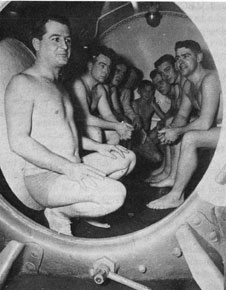 Men in a decompression chamber.