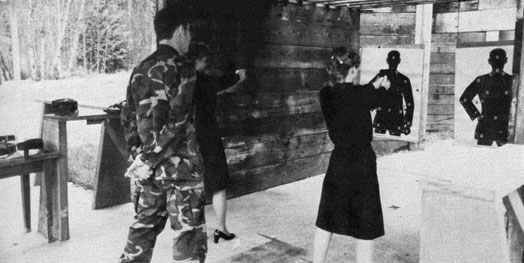 Two women firing at targets.