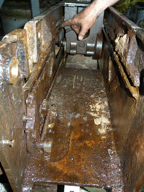 photo in breech casing with loader out showing sand, rocks, and rust packed in voids