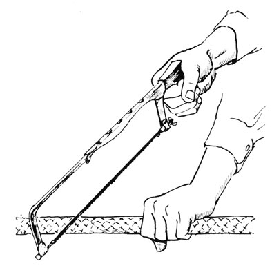 One hand holding saw, the other the cable.