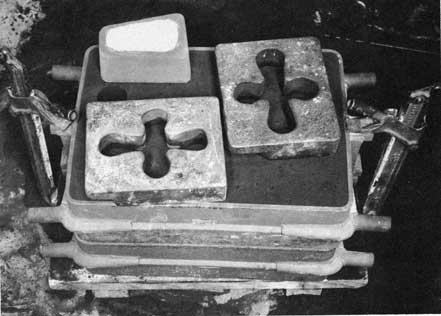 Figure 90. Clamped mold with weights and pouring basin.