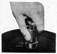 Figure 55. Disengaging Coupling Sleeve from MagazineSpring Axis.
