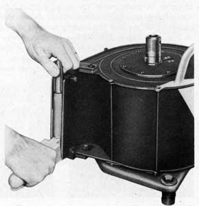 Figure 58. Unloading a Fully Tensioned Magazine. Magazine is Secured on Loading Frame
with Wedge through Hand Grip.