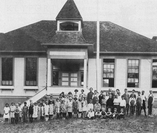 Students pose in front the school.