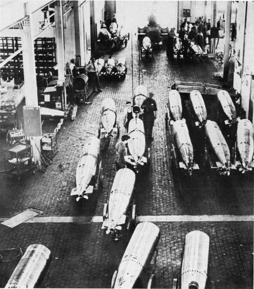 Photo of torpedoes on production floor.