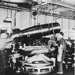 A torpedo is lowered into a test rack.