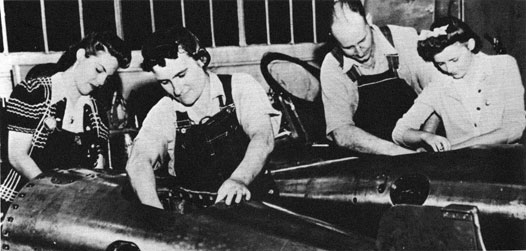 Photo of Robinson family working on two torpedoes.