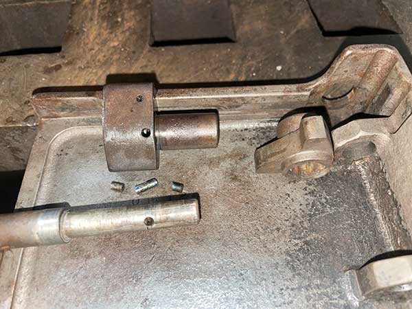 handle shaft, three bits of broken retaining pin and lever sitting in the cover