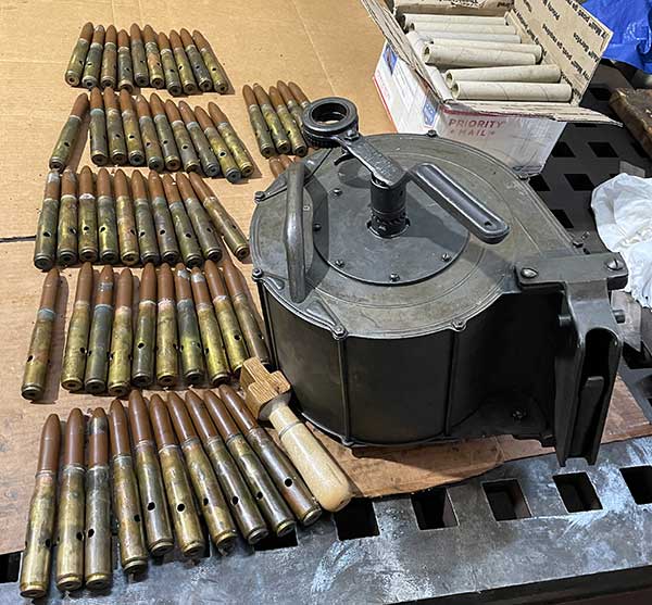 60 cartridges layed out next to the magazine.