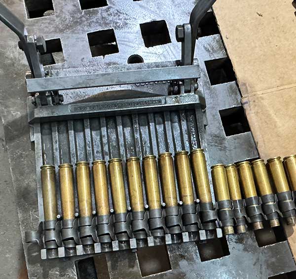 plate linker with cartridge cases in links