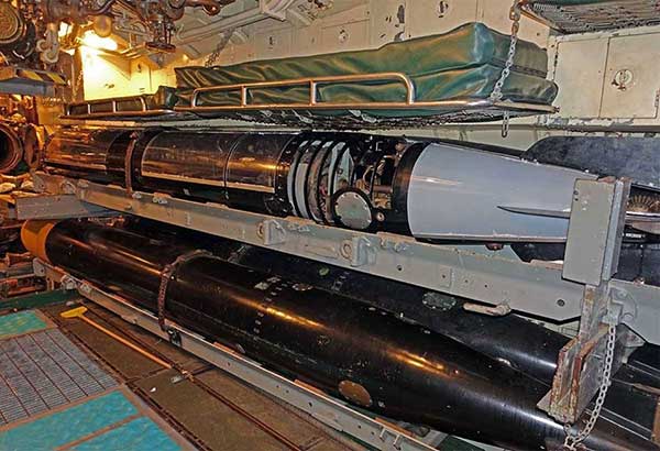 Mk 18 torpedo on tray in place in the torpedo room.  Partial visitor proofing