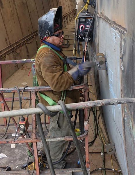 welder in a lift removing lifting eyes