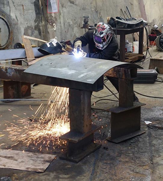 welder cutting with a plasma torch