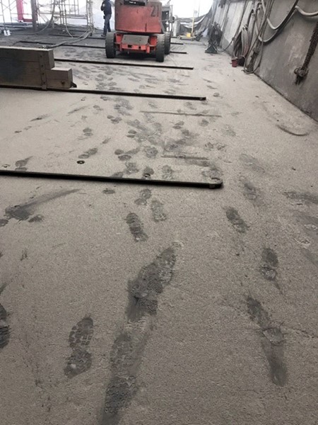 foot prints in the blast media on the floor of the drydock