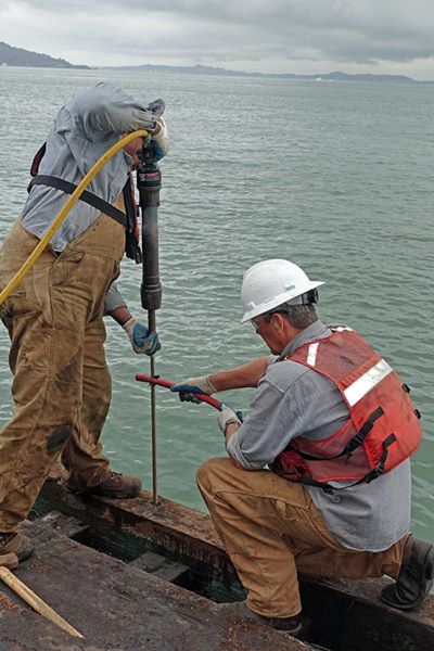 port of SF crew drilling a hole in the pier