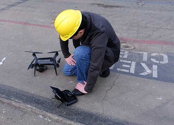 3D Robotics drone before takeoff with keep clear painted on pier