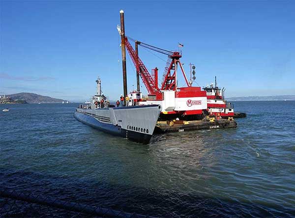 pampanito tied to crane barge moving into position on pier