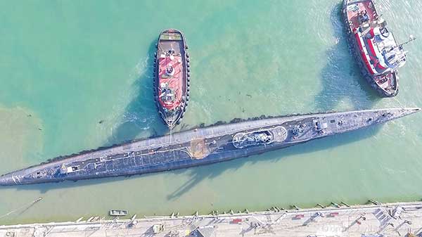 photo taken from directly above Pampanito with two tugs pulling away from pier