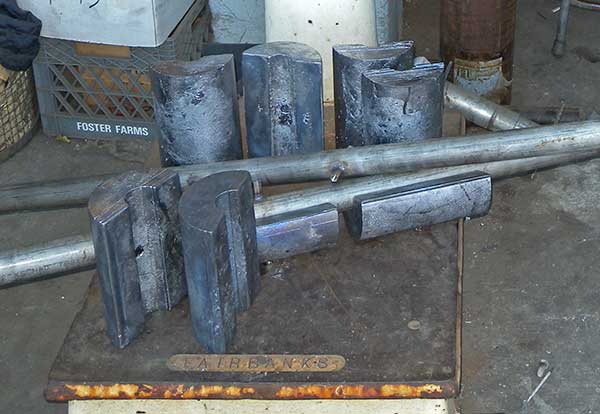 Pile of weights and two centering pipes.