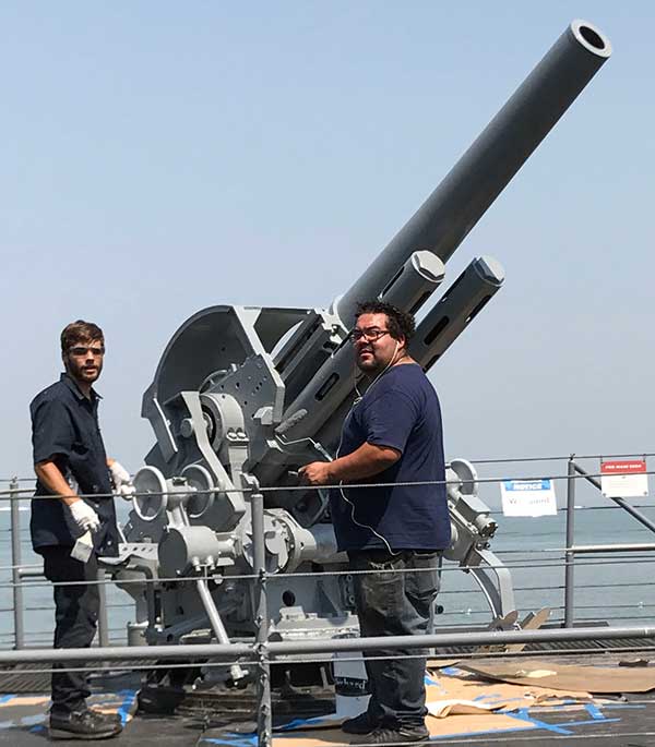 gun elevated with crew painting.