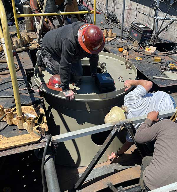 crew fitting foundation to boat