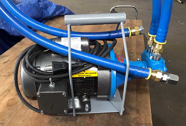 pump with hoses on bench