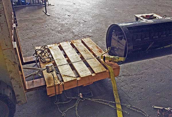 photo of battery being removed with small chain hoist