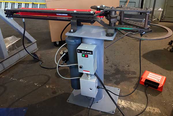 Hossfeld bender mounted on stand with hydraulic cylinder installated.