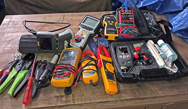variety of electrical tools laid out on a table